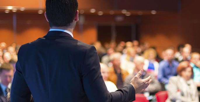 A candidate standing in front of a crowd.