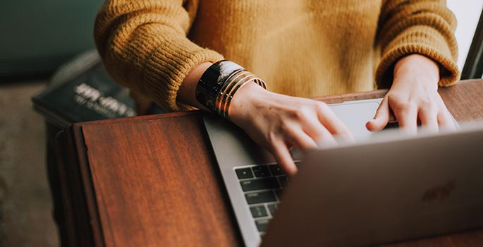 A person using a laptop to vote.