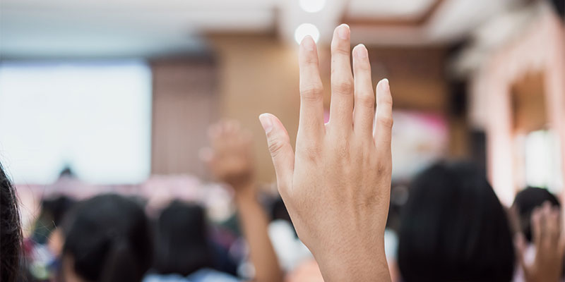 Person raising their hand.